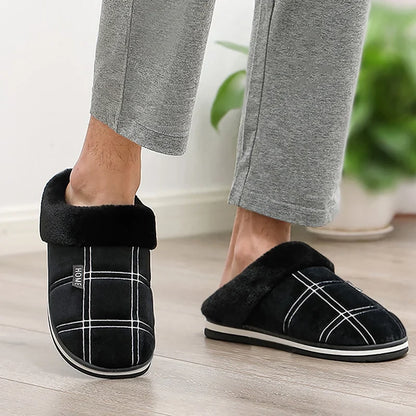 Pair of grey Cozy plush slippers laid flat on wooden floor