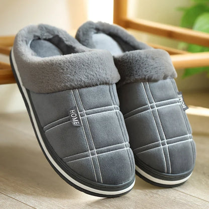 Side profile of black Cozy plush slippers showing sole height