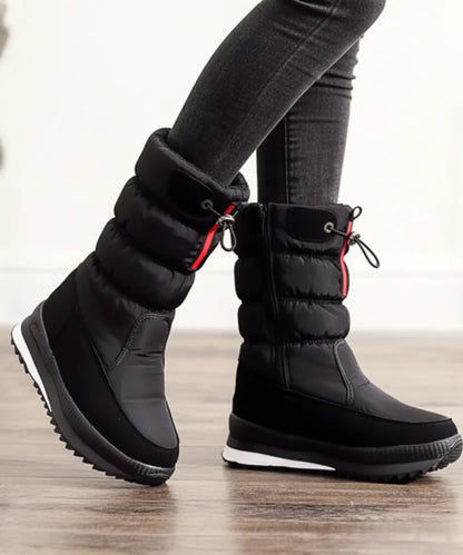 Lilica puffer snow boots worn with jeans on winter pavement