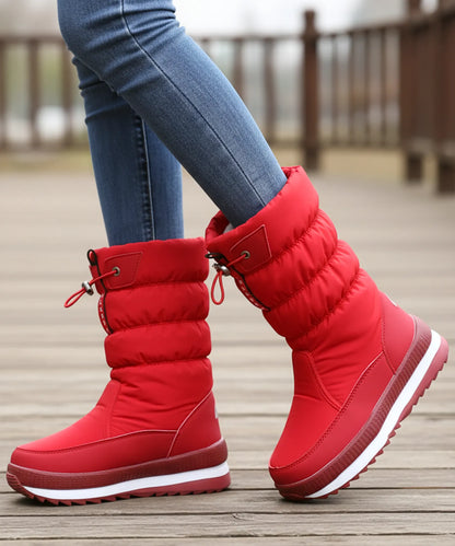 Adjustable drawstring top opening on women's quilted snow boot shaft