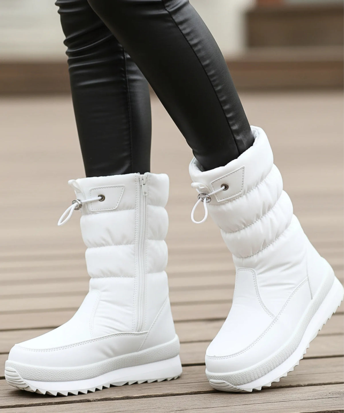 Black quilted puffer snow boot with sherpa lining and side zipper closeup
