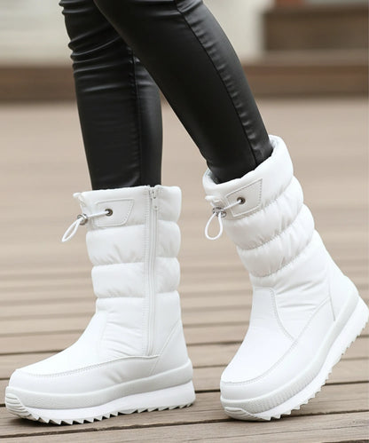 Black quilted puffer snow boot with sherpa lining and side zipper closeup