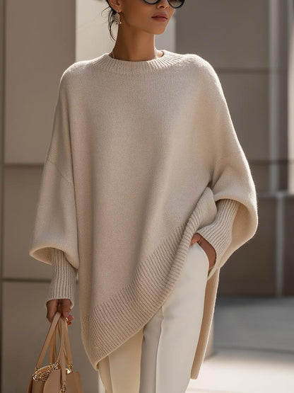 Liora women's oversized knit poncho in beige with batwing sleeves and asymmetric hemline
