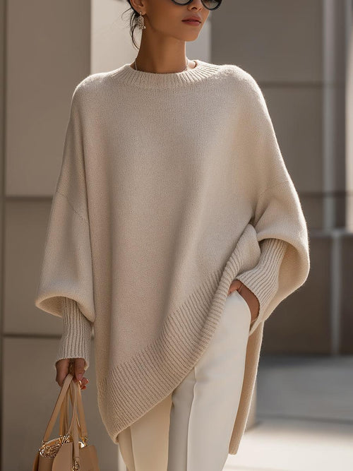 Liora women's oversized knit poncho in beige with batwing sleeves and asymmetric hemline