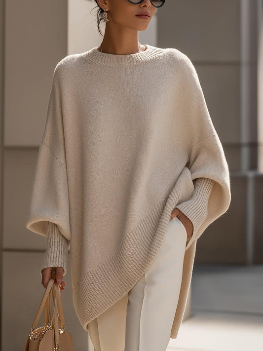 Liora women's oversized knit poncho in beige with batwing sleeves and asymmetric hemline