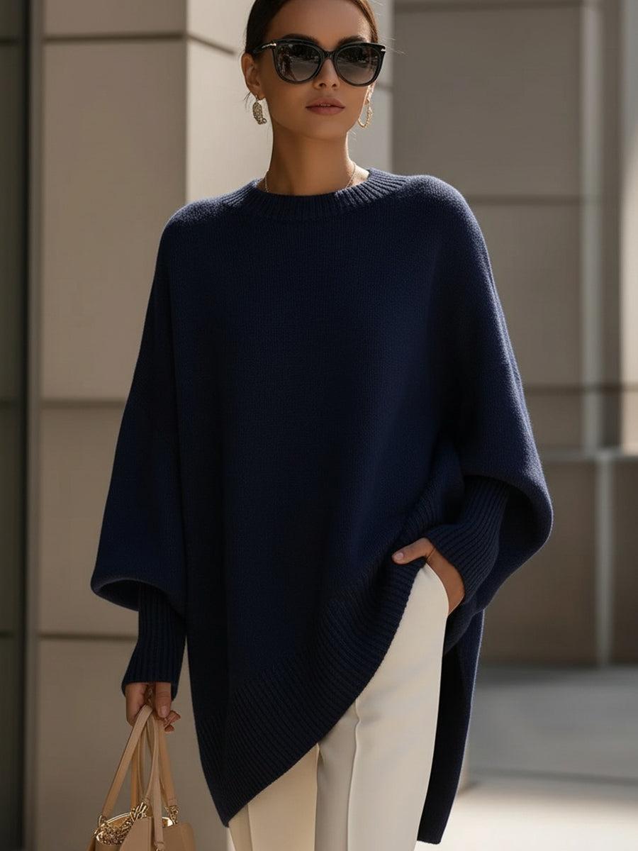 Liora knit poncho in navy blue draped over the body with wide batwing sleeves