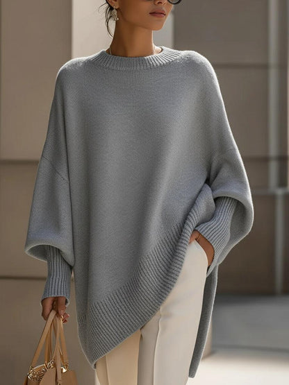 Liora oversized poncho in caramel paired with tailored trousers for a chic layered look
