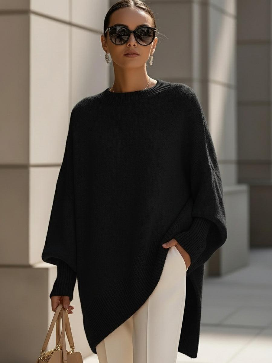 Side view of Liora poncho in olive green highlighting the asymmetric hemline