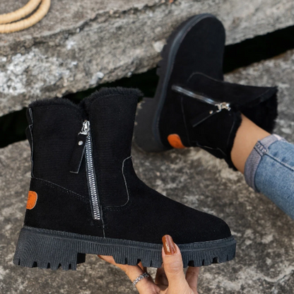 Women's zip-up winter boots in beige on snowy surface