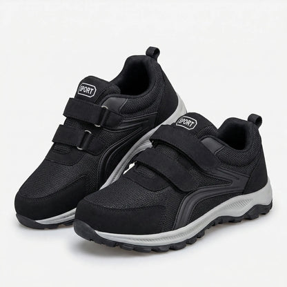 Aldor wide-fit walking trainers shown from the side in dark blue