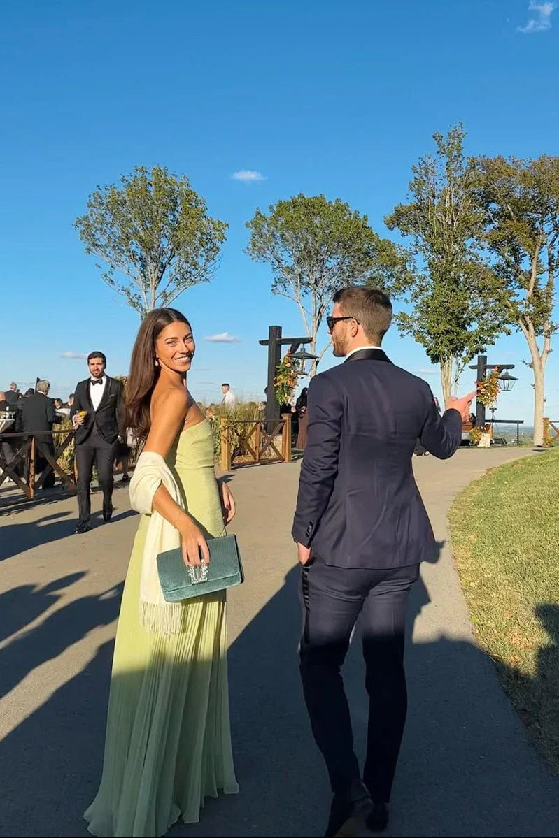 Women's elegant green maxi dress worn at a wedding event