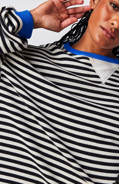 Side view of Velma casual sweater showing relaxed silhouette and stripe detail
