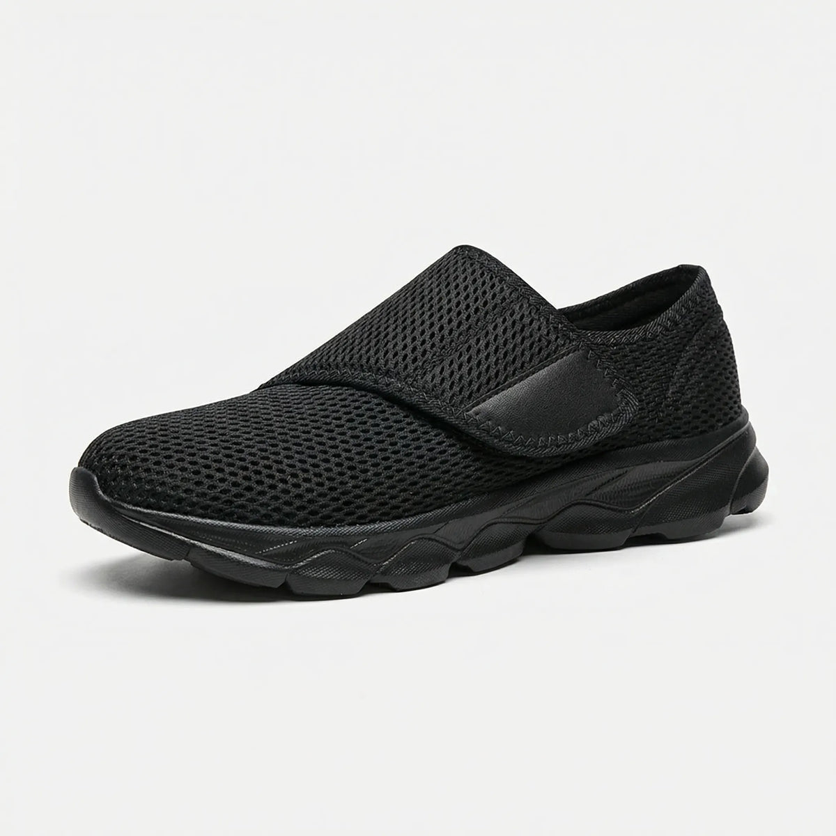 Side view of women's wide-fit walking shoe with breathable mesh upper in black