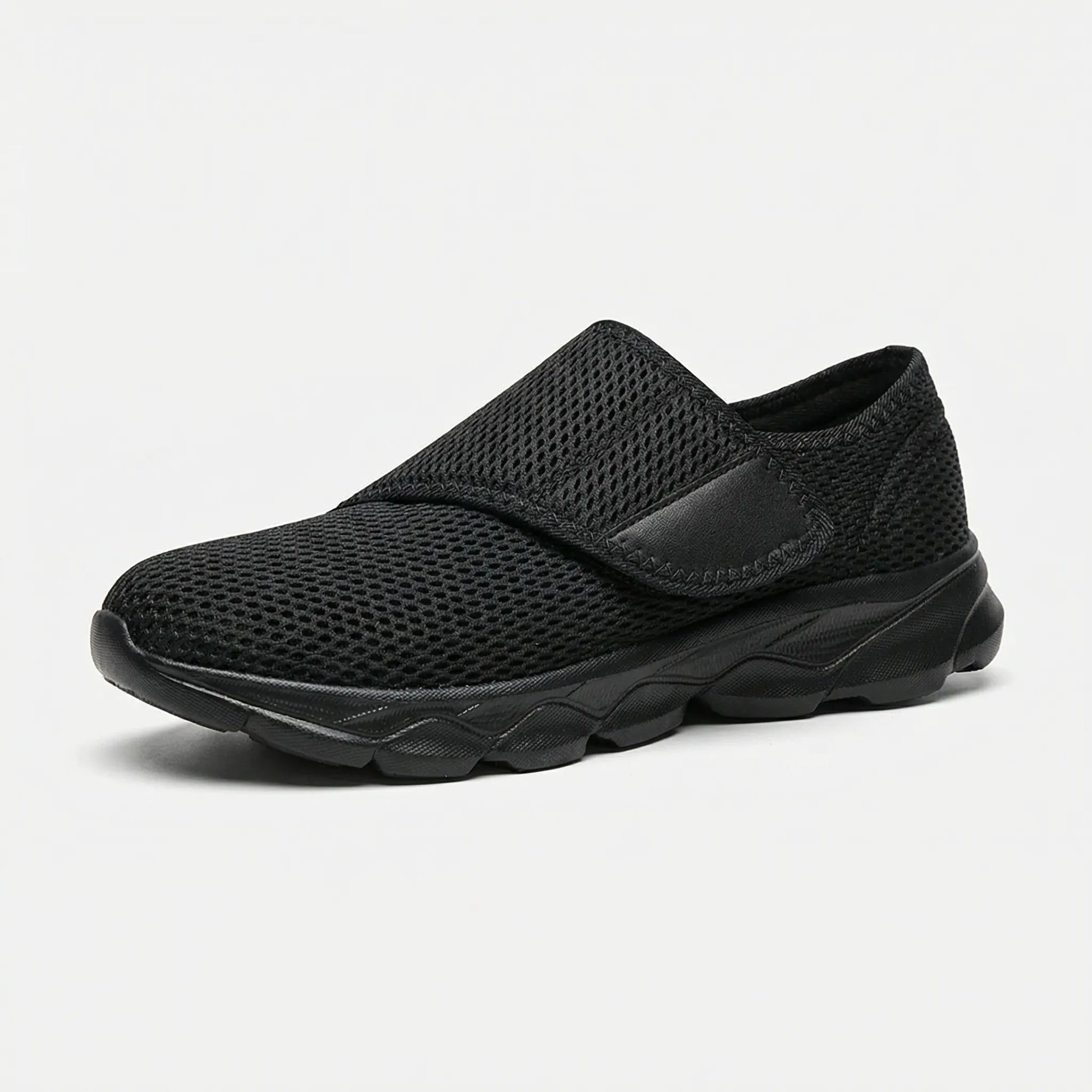 Side view of women's wide-fit walking shoe with breathable mesh upper in black