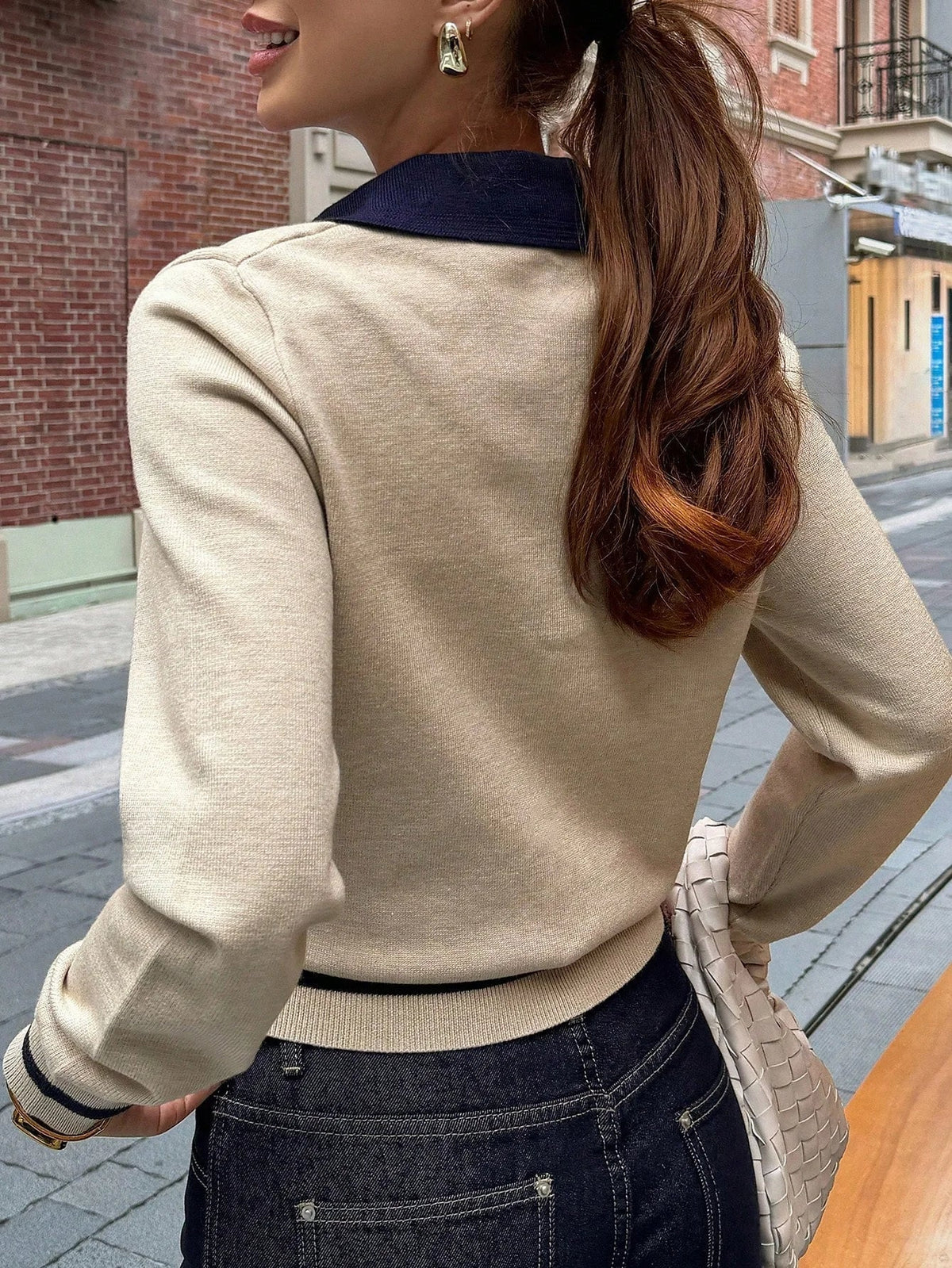 Close-up of ribbed knit texture on khaki color block polo top