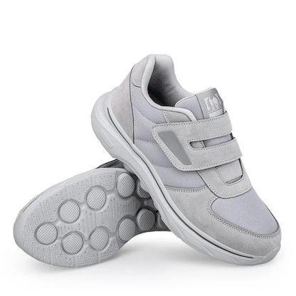 Pair of women's orthopedic sneakers with stable flat heel construction