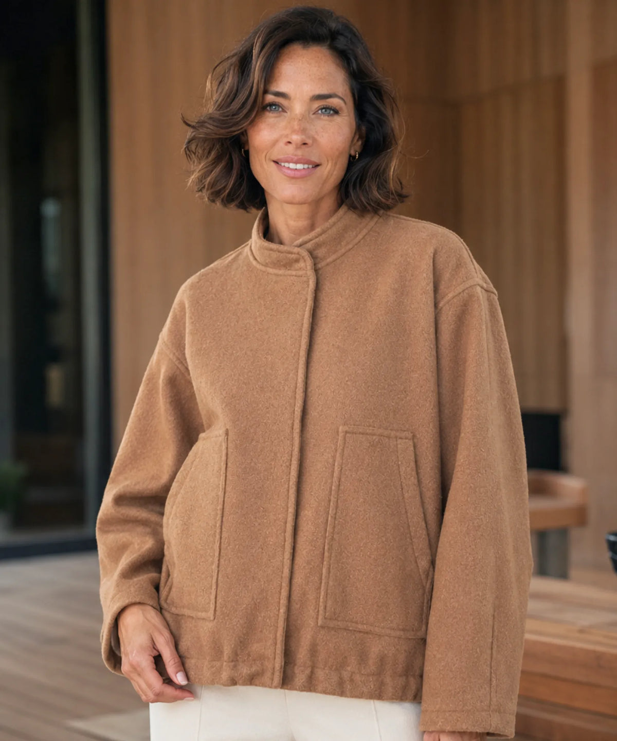 Back view of women's oversized bouclé bomber jacket in charcoal