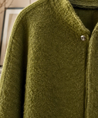 Close-up of bouclé wool fabric texture on white bomber jacket