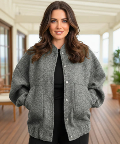 Charcoal bouclé bomber jacket worn as a layering piece in cold weather