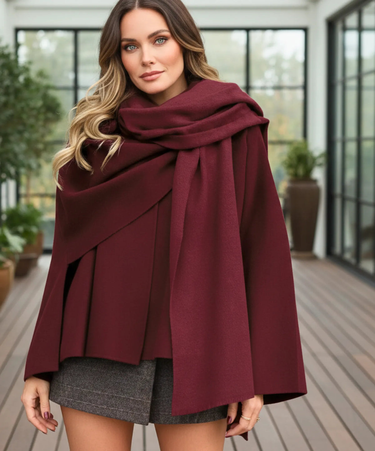 Woman wearing oversized wool wrap coat styled with tailored trousers