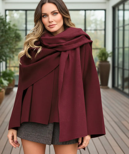 Woman wearing oversized wool wrap coat styled with tailored trousers