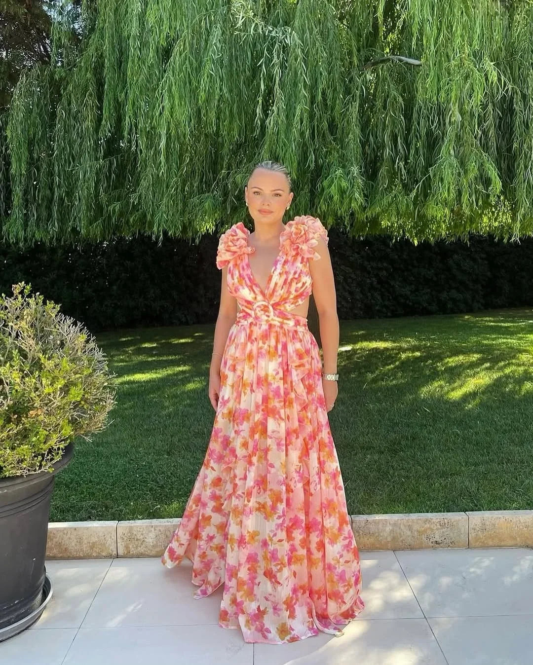 Back view of sleeveless floral maxi dress with flattering silhouette