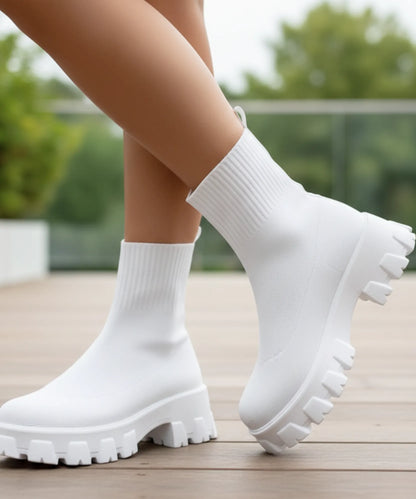 Close-up of chunky lug sole on women's stretch knit sock boot