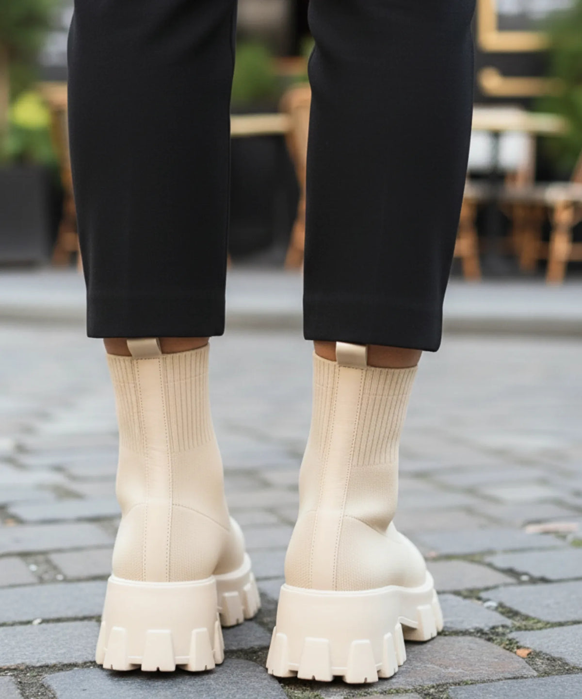 Women's chocolate brown sock boot styled with straight-leg jeans