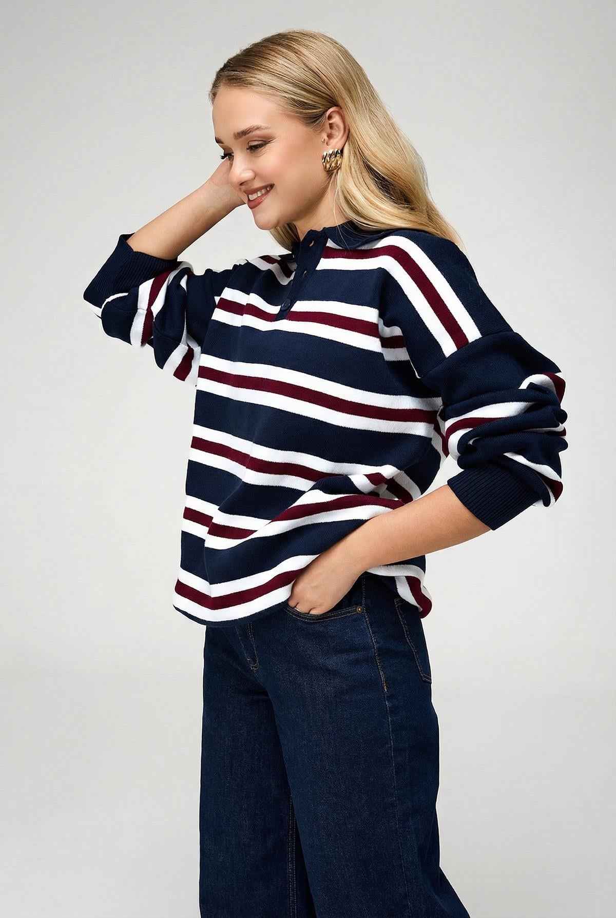 Close-up of button detail on women's navy blue polo neck jumper