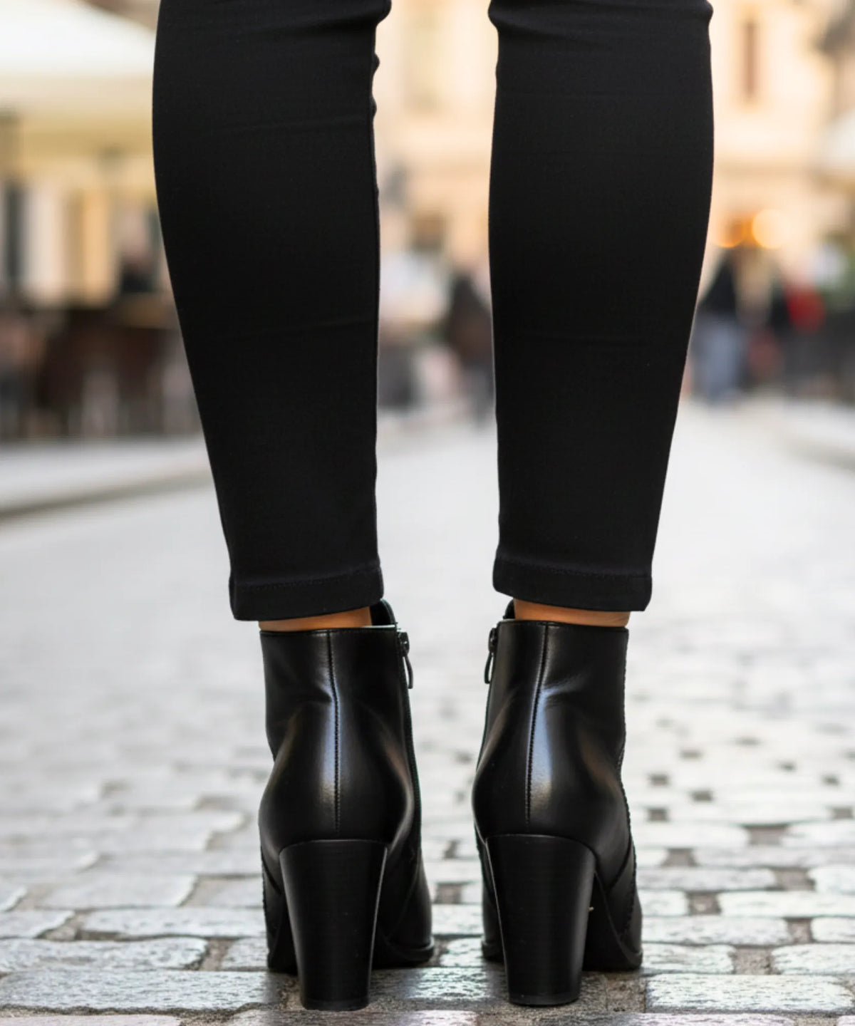 Serena black ankle boots with perforated seam detail and structured silhouette