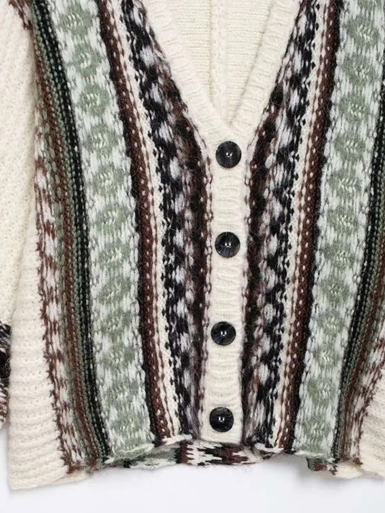 Women's cable knit sweater shown from the back, oversize silhouette