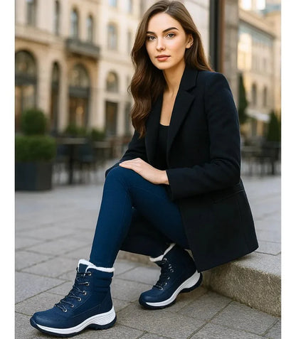 Wide platform rubber outsole of women's quilted snow boots showing deep tread grip