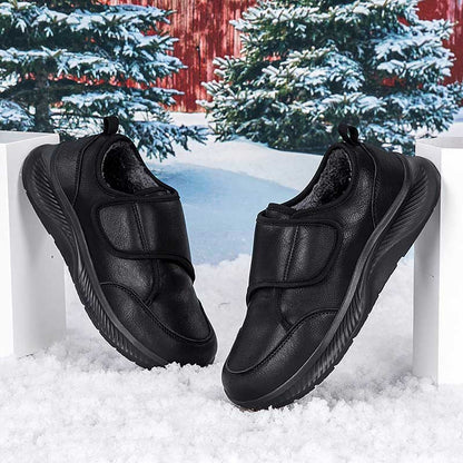 Women's black nursing sneakers displayed on plain background