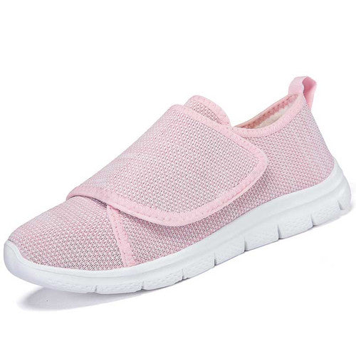 Pair of Nora black nursing sneakers with wide velcro closure