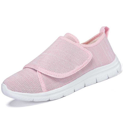 Pair of Nora black nursing sneakers with wide velcro closure