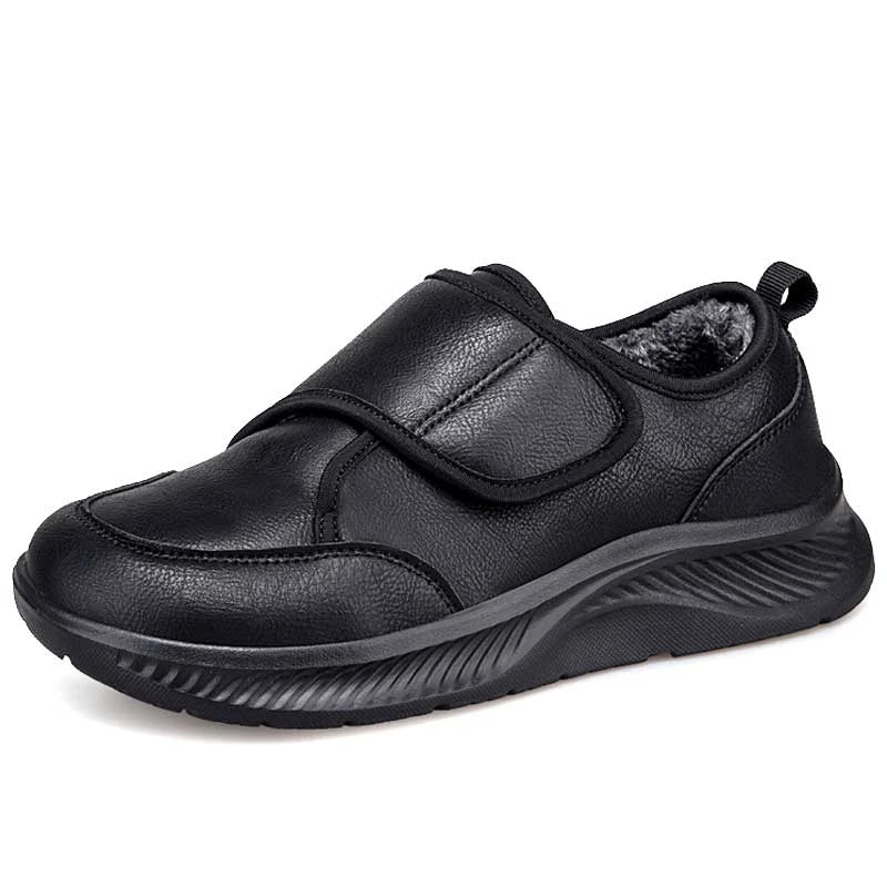 Side view of black slip-on nursing sneaker with velcro strap