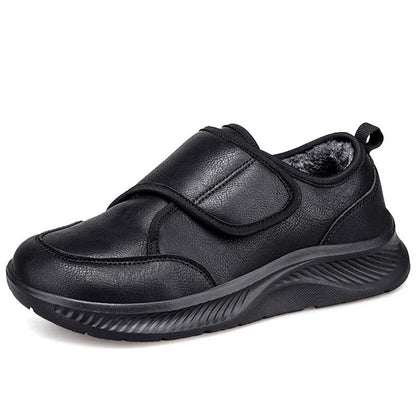 Side view of black slip-on nursing sneaker with velcro strap