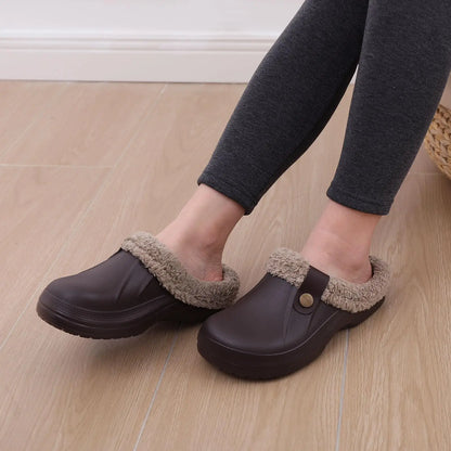 Wren warm winter slippers in brown shown on a light wooden floor